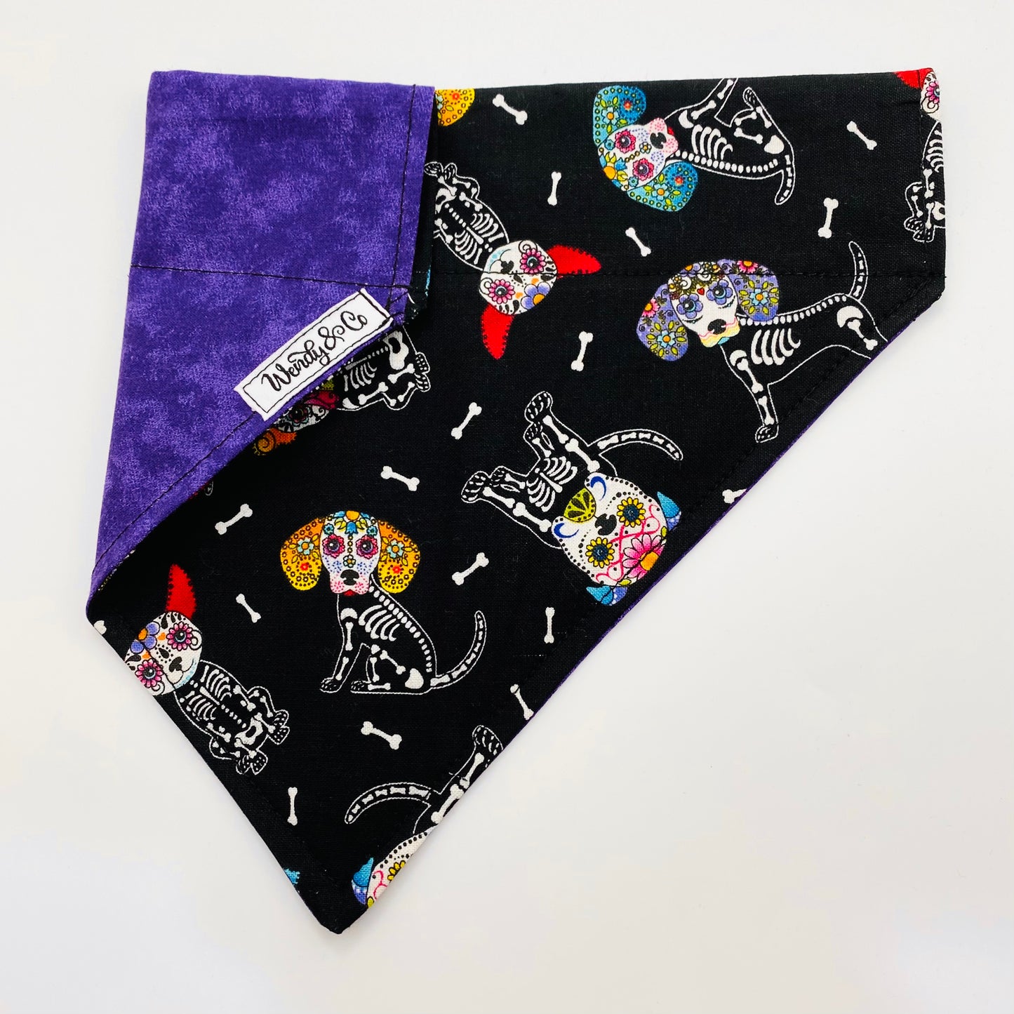 Skull candy doggies on a reversible dog bandana.