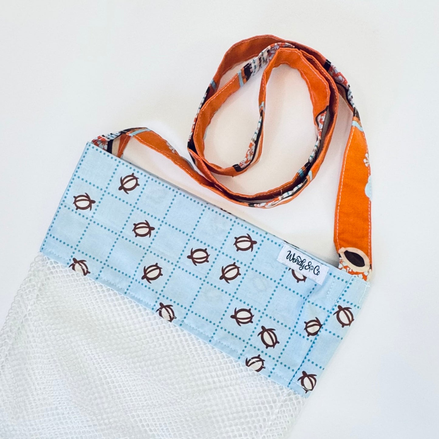 Crossbody seashell bag in blue with turtles.