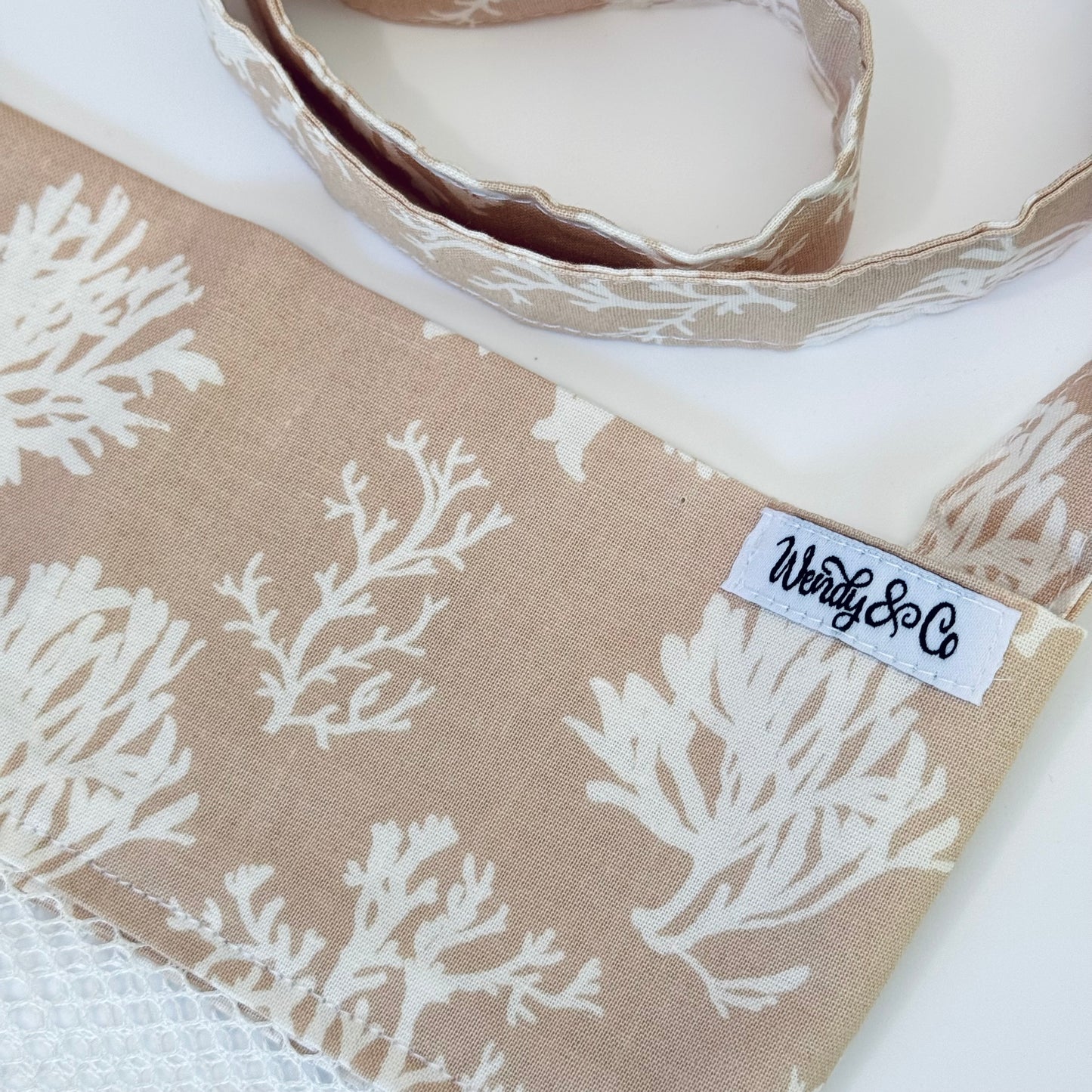 Crossbody seashell bag in neutral colors.