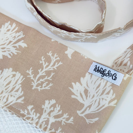 Crossbody seashell bag in neutral colors.