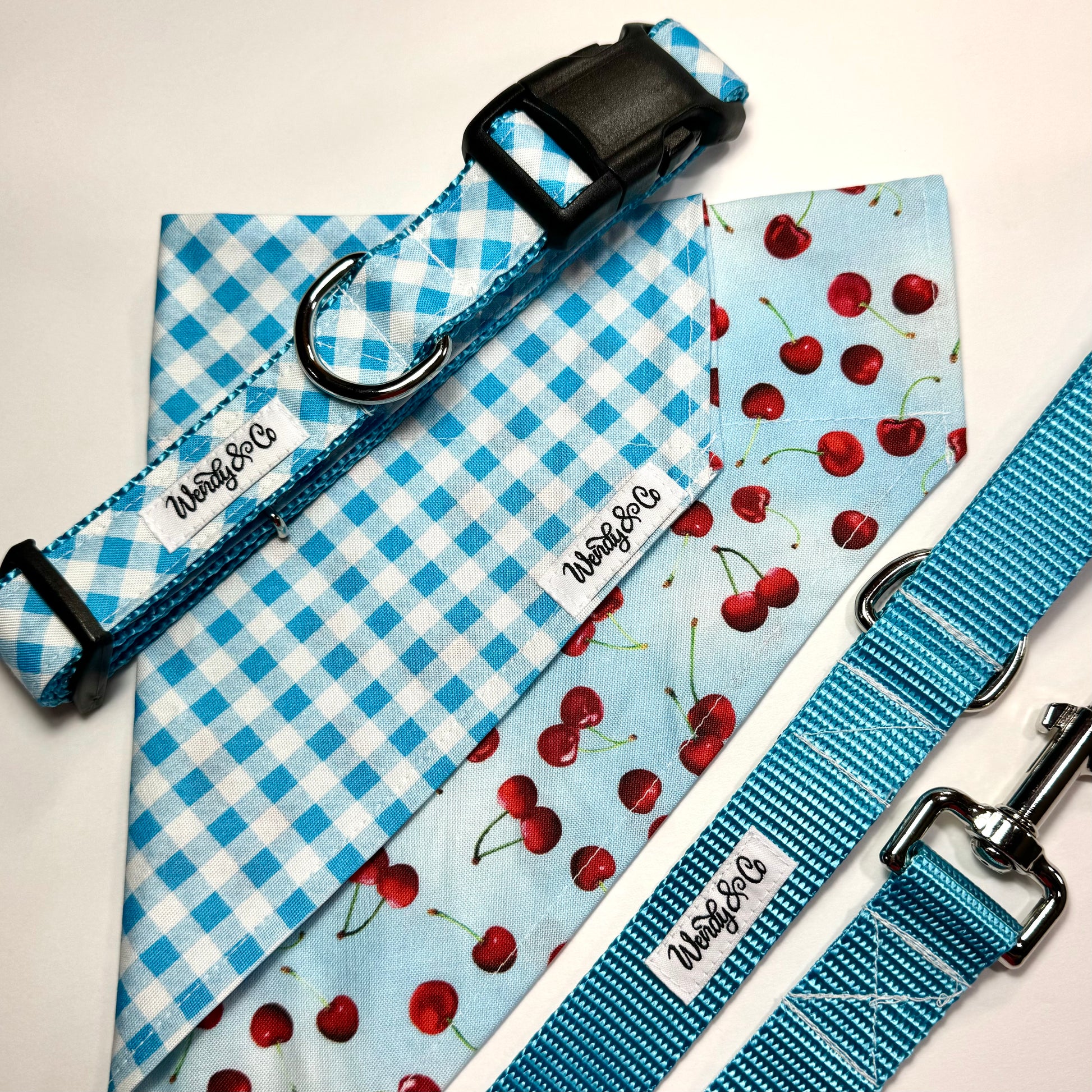 Cherry bandana with blue plaid, shown with collar and leash.