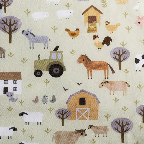 Close up of Homestead print with farm animals and tractors on soft green background.