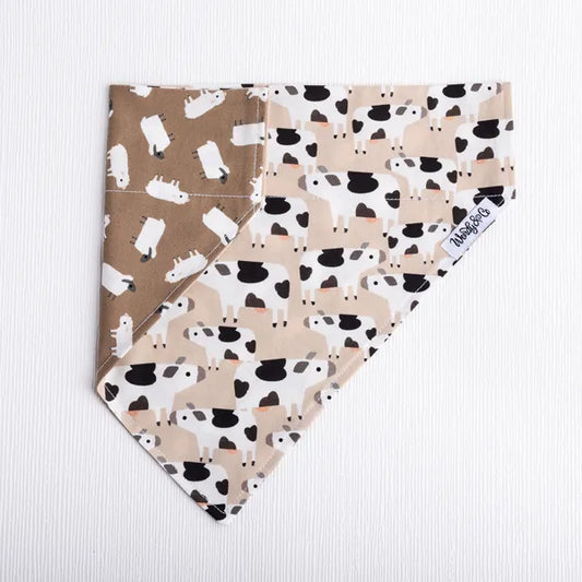 Reversible dog bandana with farm print with sheep and cows.