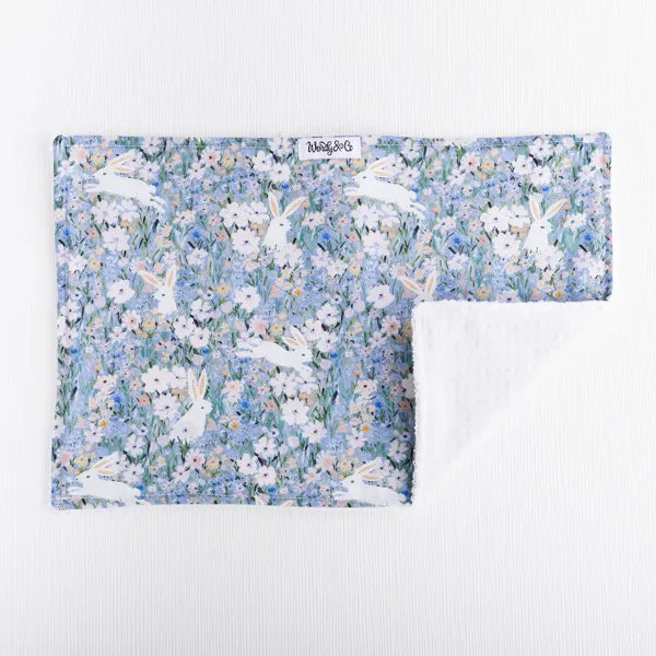 Soft baby burp cloth with rabbits and blossoms.