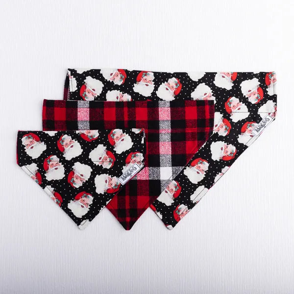 Dog bandana with festive Santa print and cozy red and black plaid reverse.