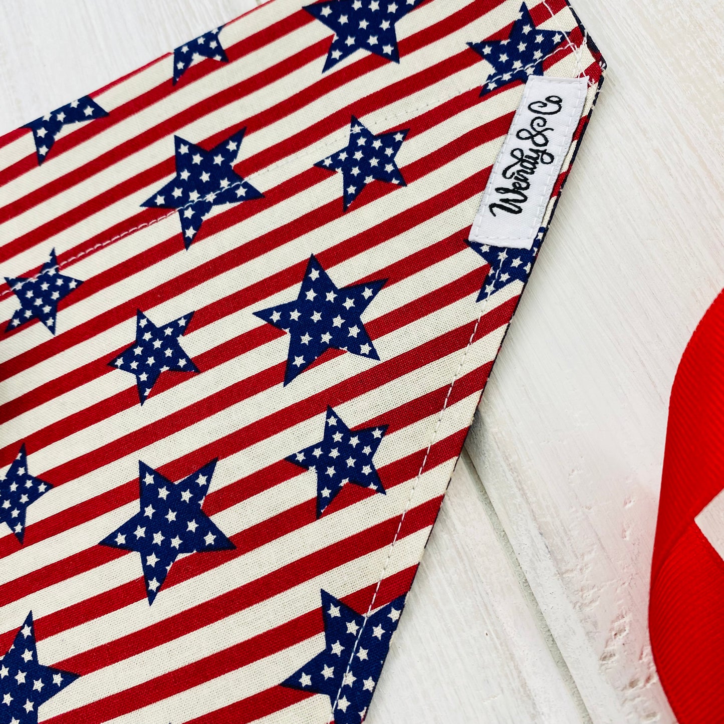 Red and cream stripes with navy stared stars dog bandana.