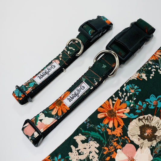 Dog collar and bandana in elegant emerald green background with a bouquet of wildflowers.