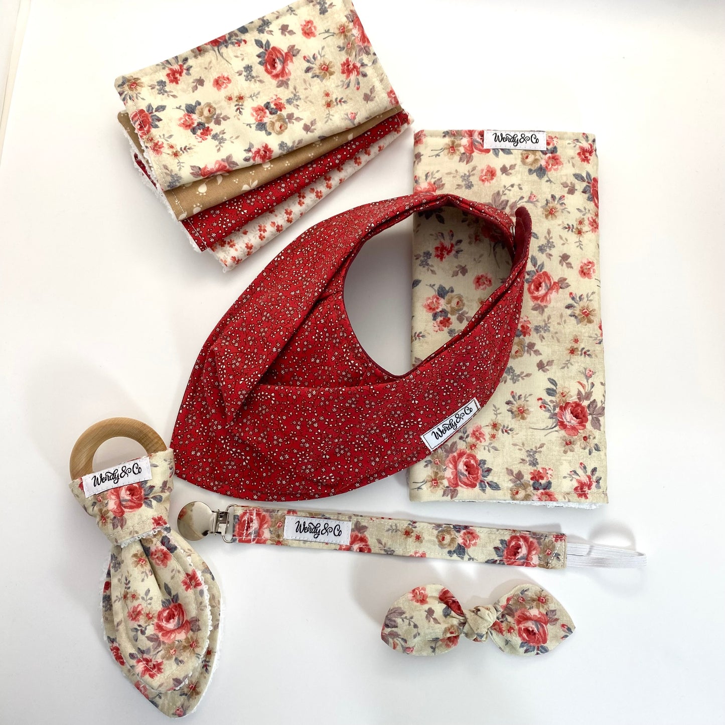 Baby gift set with washing cloths, bib, burp cloth, paci clip, bow and teether.