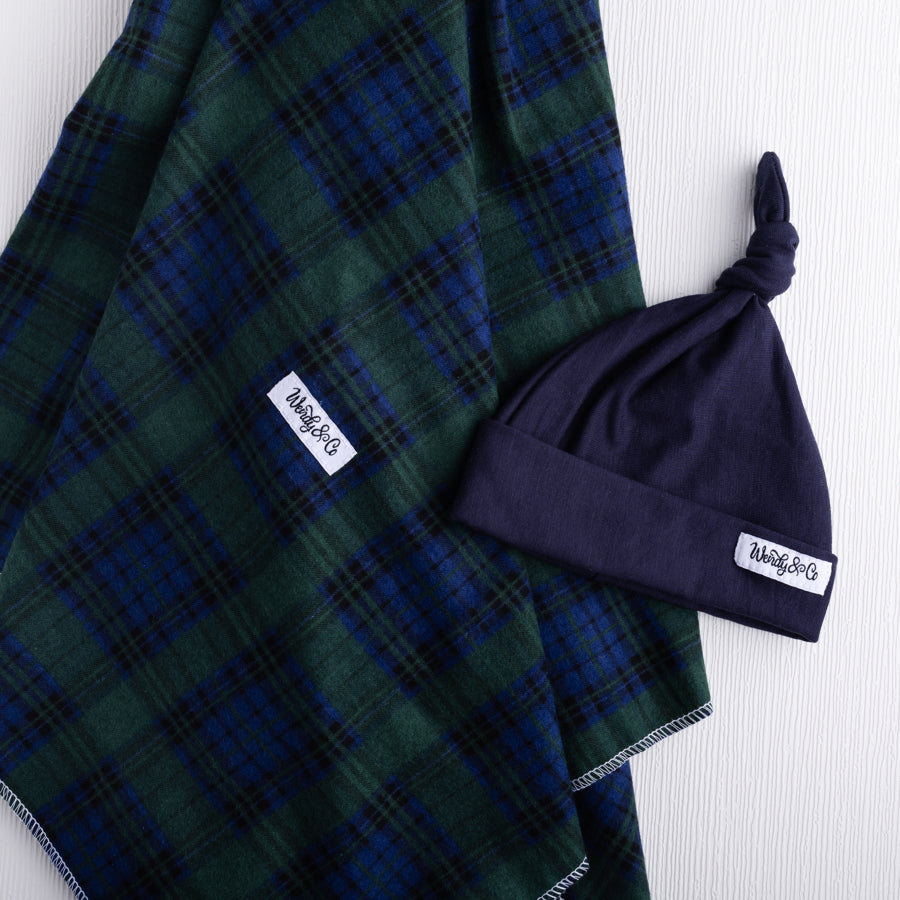 Green and navy plaid flannel baby blanket.