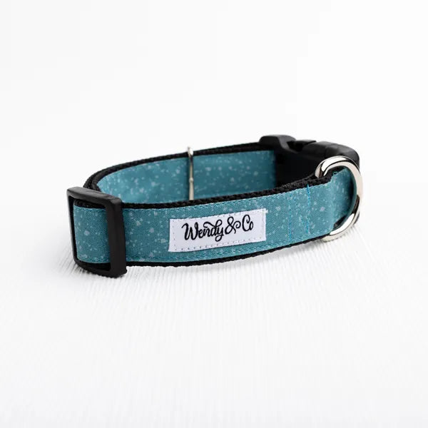 A teal blue glitter dog collar with black trim, a white brand label reading 'Wendy & Co', and a silver metal buckle, shown on a clean white background.