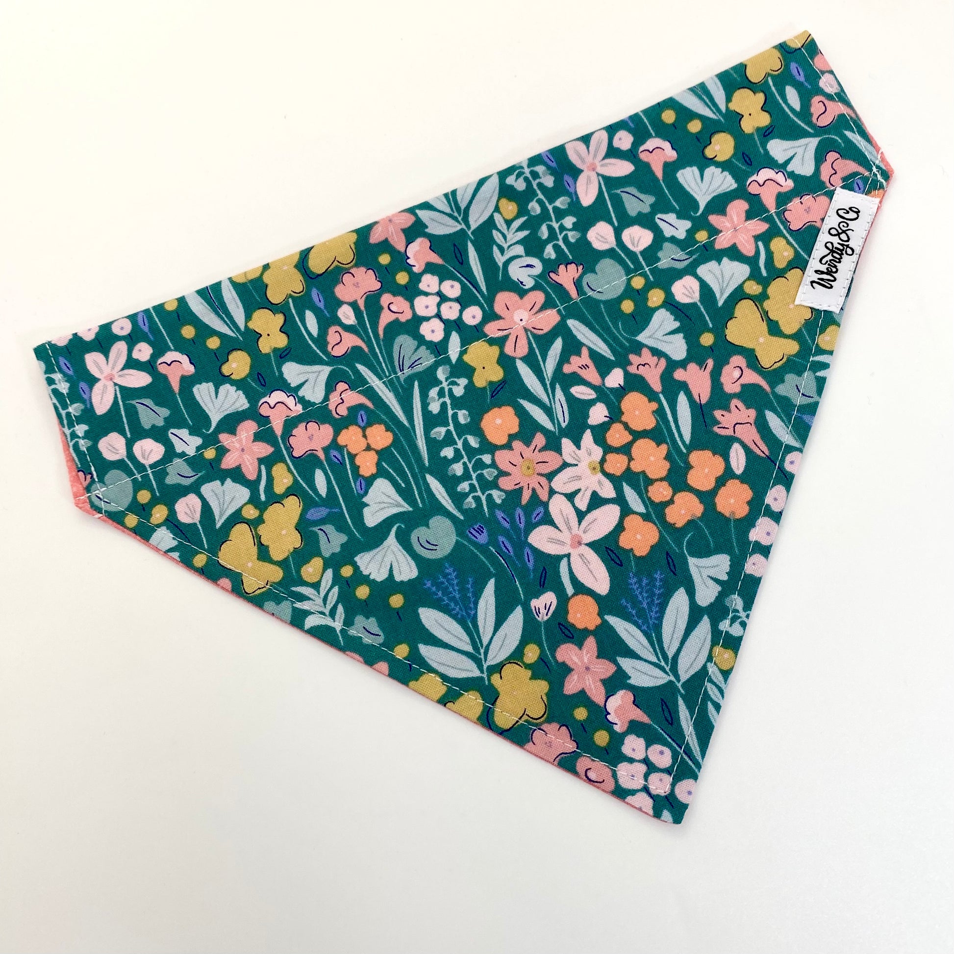 Pastel floral dog bandana that’s reversible and slides over the collar.