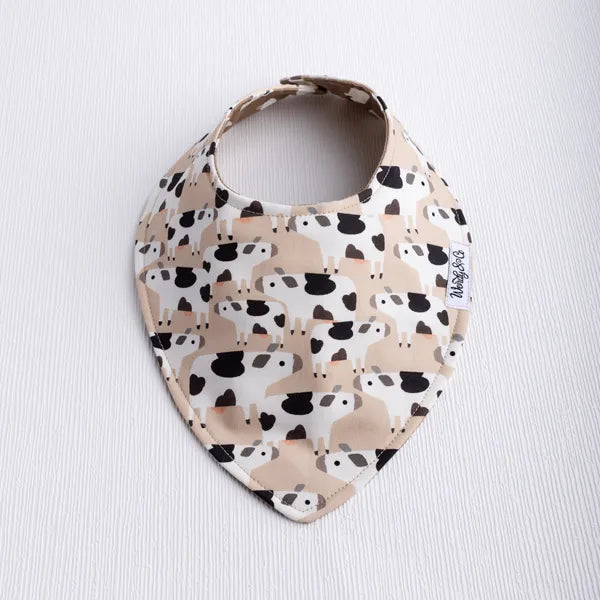 Smooth front, reversible baby bib with cow print on one side and sheep print on the other from the Legend-Dairy collection.