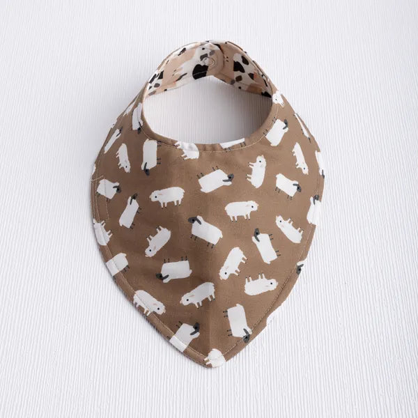 Reversible baby bib with sheep in neutrals.