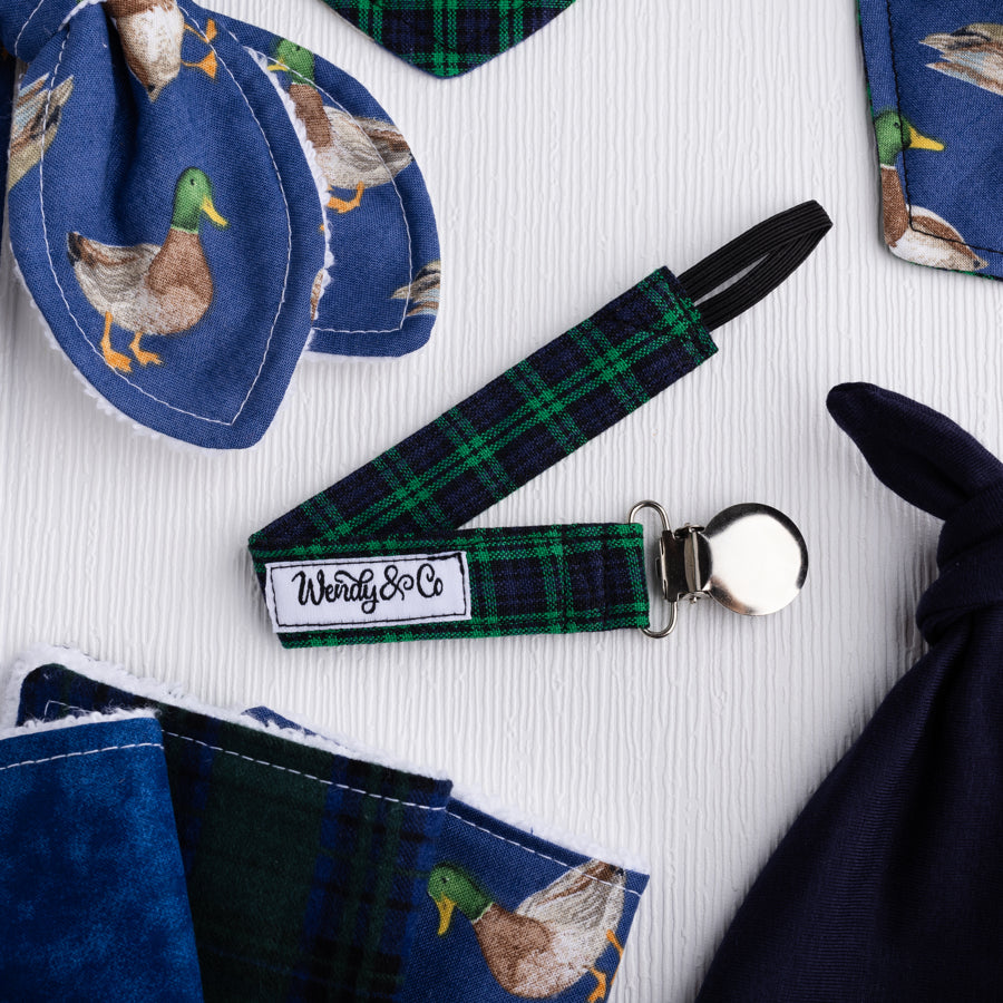 Navy and green plaid pacifier clip.