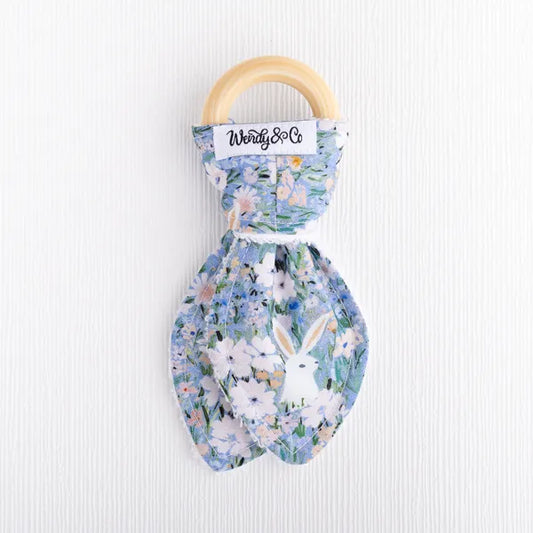 Wooden teether with bunny and floral fabric.