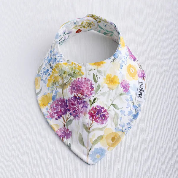 Buttercup baby bib with soft flower print in yellow tones.