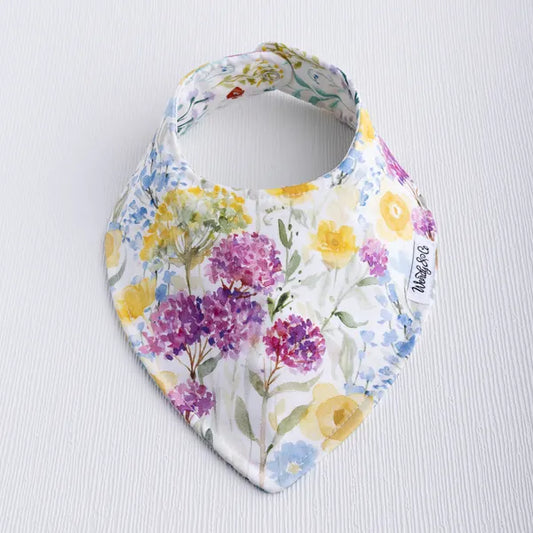 Buttercup baby bib with soft flower print in yellow tones.