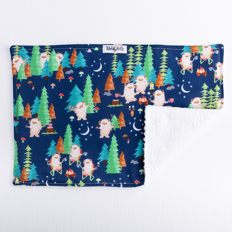 Burp cloth with sasquatch or big foot characters. 