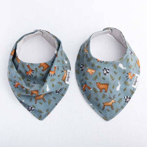 Smooth front and bandana front Whispering Woods baby bib featuring woodland pattern in soft earth tones.
