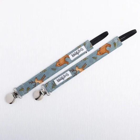 Baby pacifier clip in woodland print.
