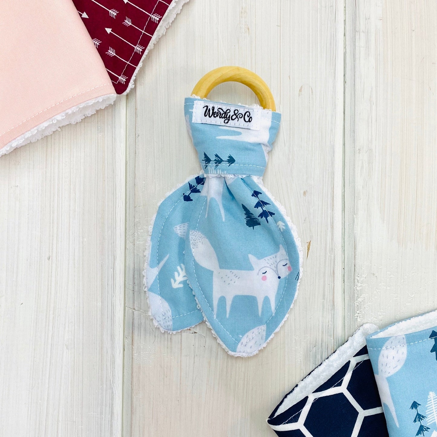 cute silver gray fox print on blue background fabric and wood teether 