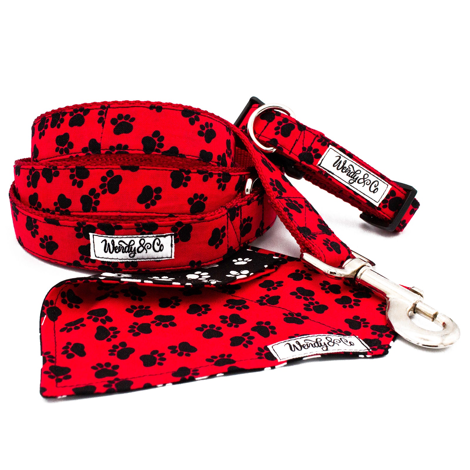 Dog leash, collar and bandana in bright red with black paws.