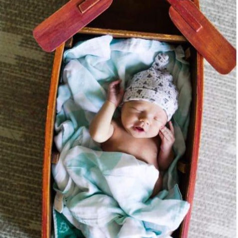 Newborn photo of baby with soft beanie.