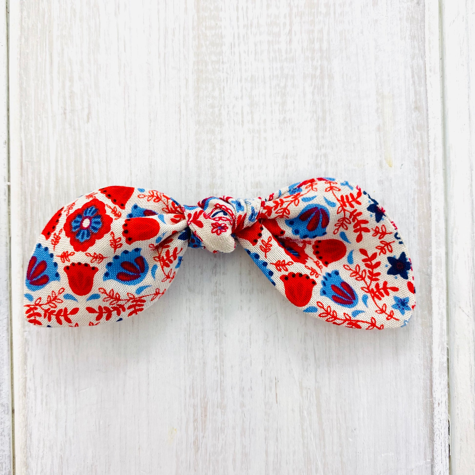 Baby bow headband or alligator clip in red blue and cream.