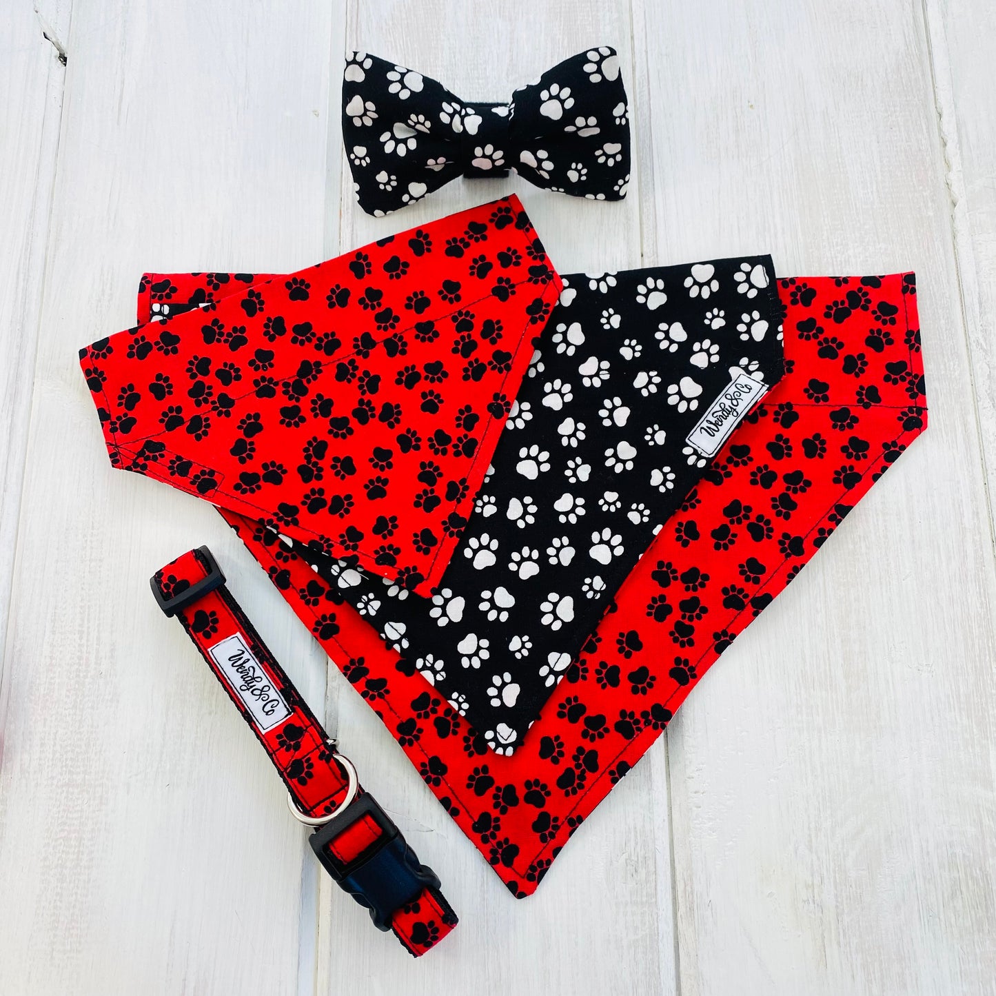Pet bow tie, bandana and collar in red and black paws, and black and white paws.