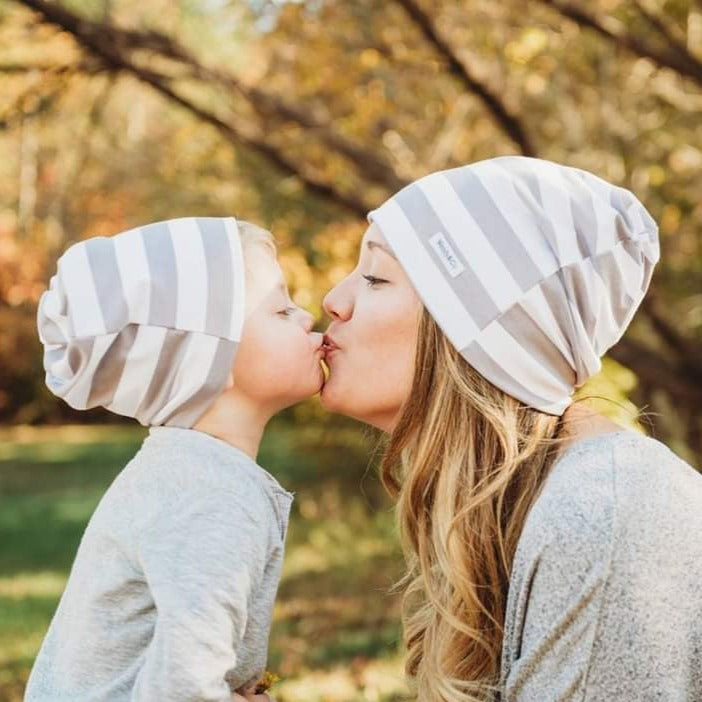Mommy and me, mother and son in matching beanies.