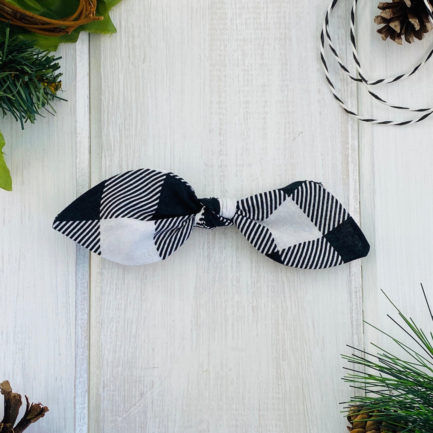 Baby bow on alligator clip in black and white buffalo check.