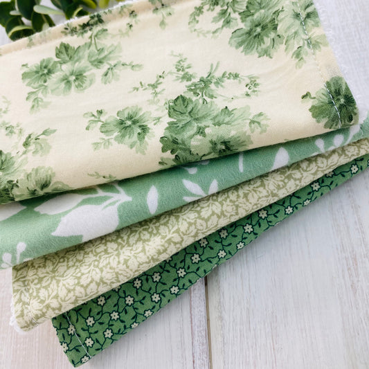 Set of 4 baby washing cloths in soft green floral prints.