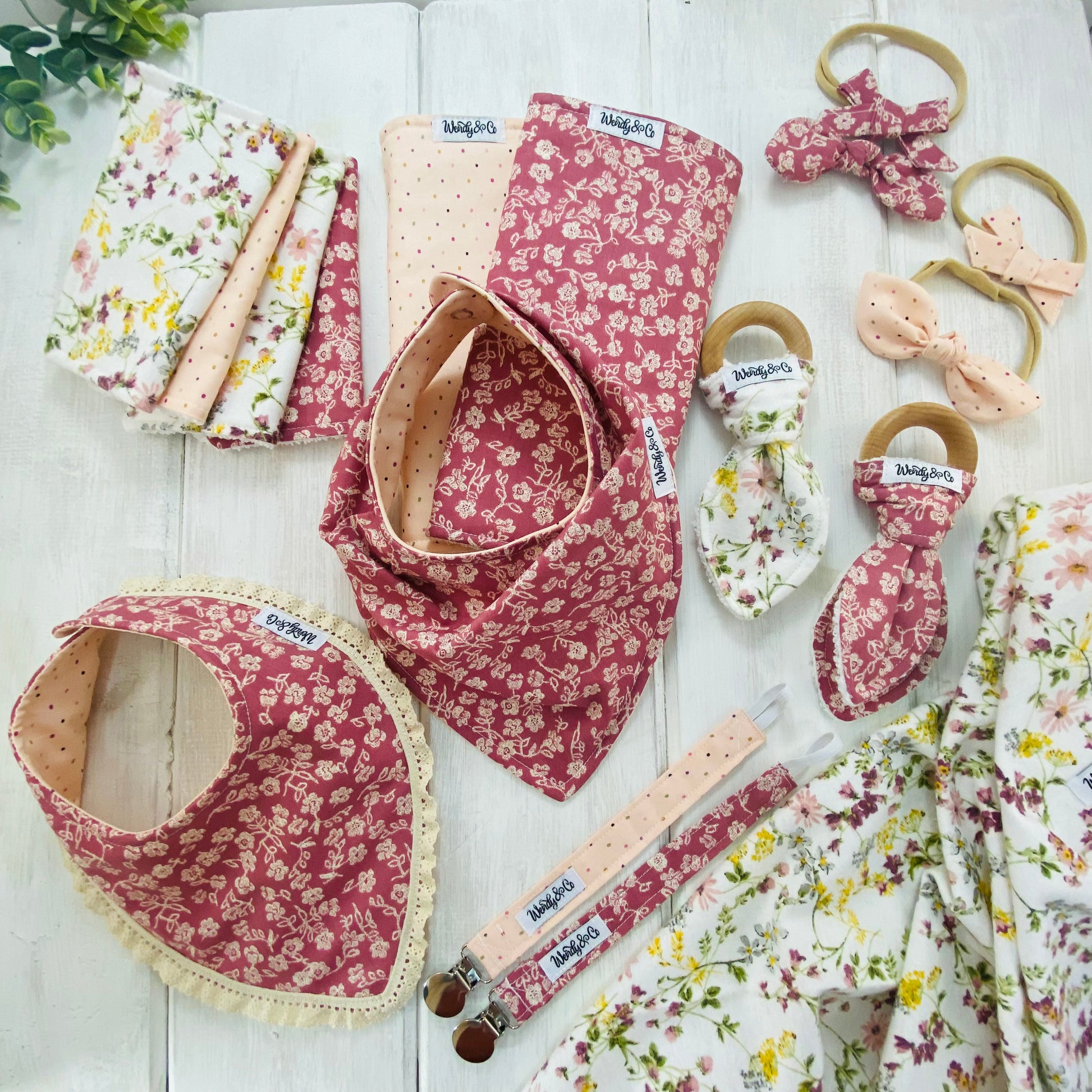 Vintage handmade baby layette in pink and cream florals.