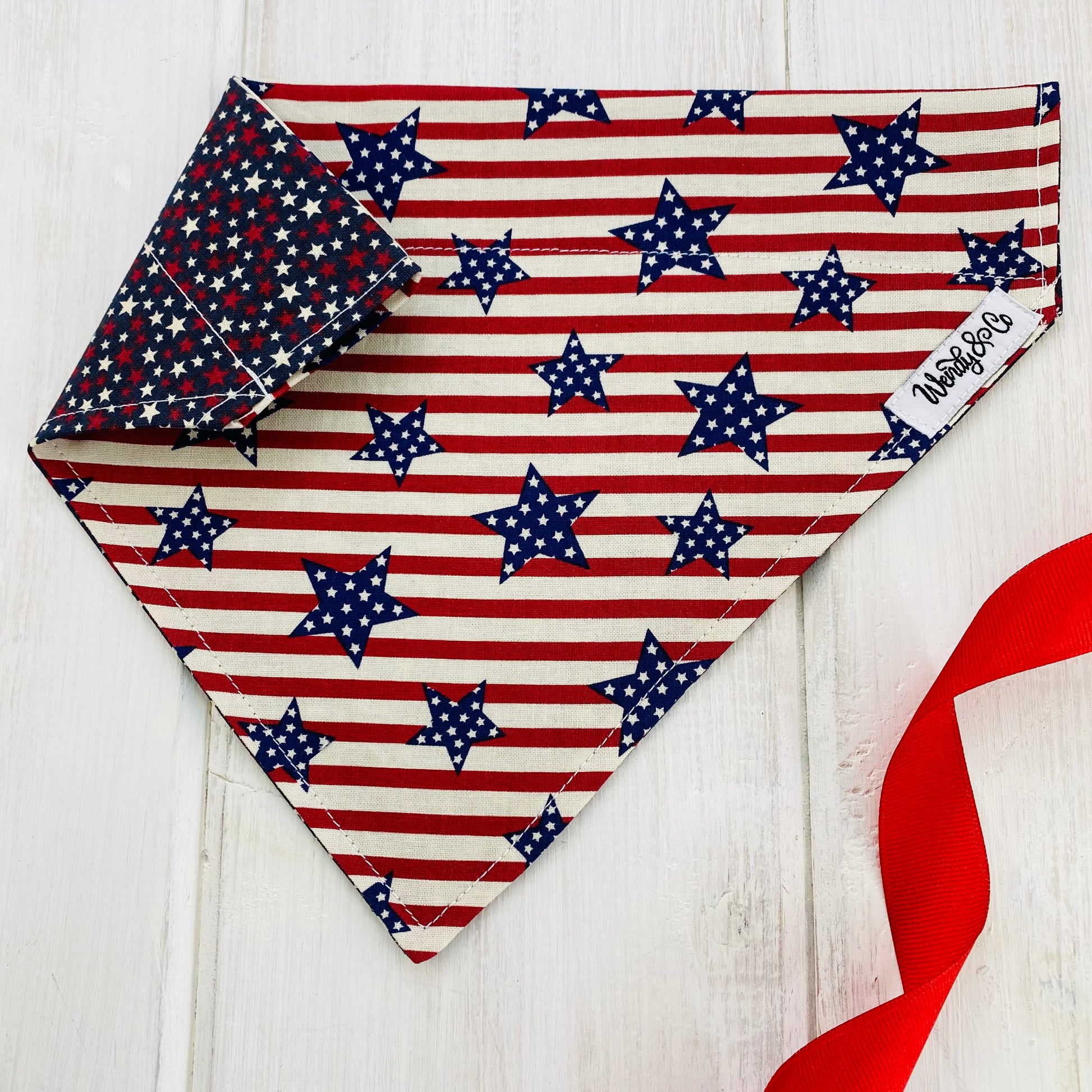 Represent USA with our patriotic dog bandana- red, white and navy blue stars on one side, and patriotic red stripes with navy stars on the other side.