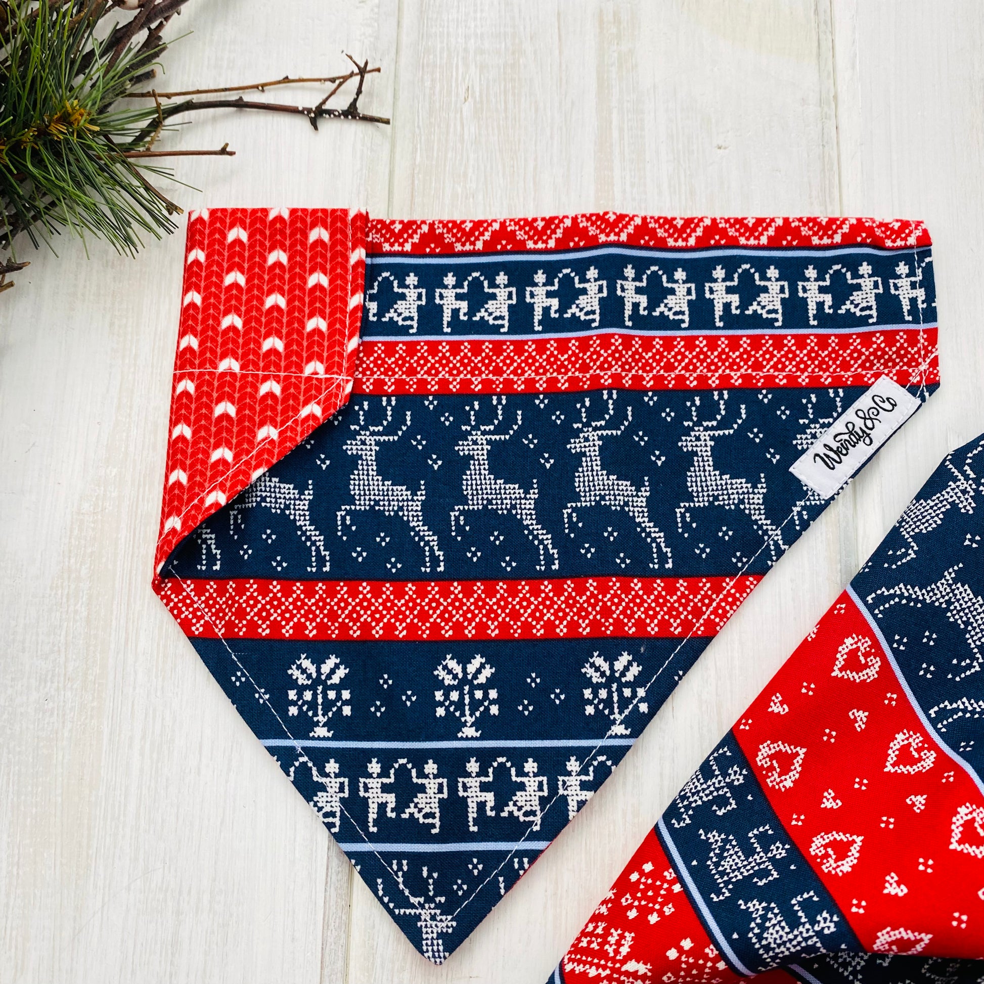 Celebrate winter with this Nordic style print with rows of stitched deer, and florals. Shown with red sweater reverse.