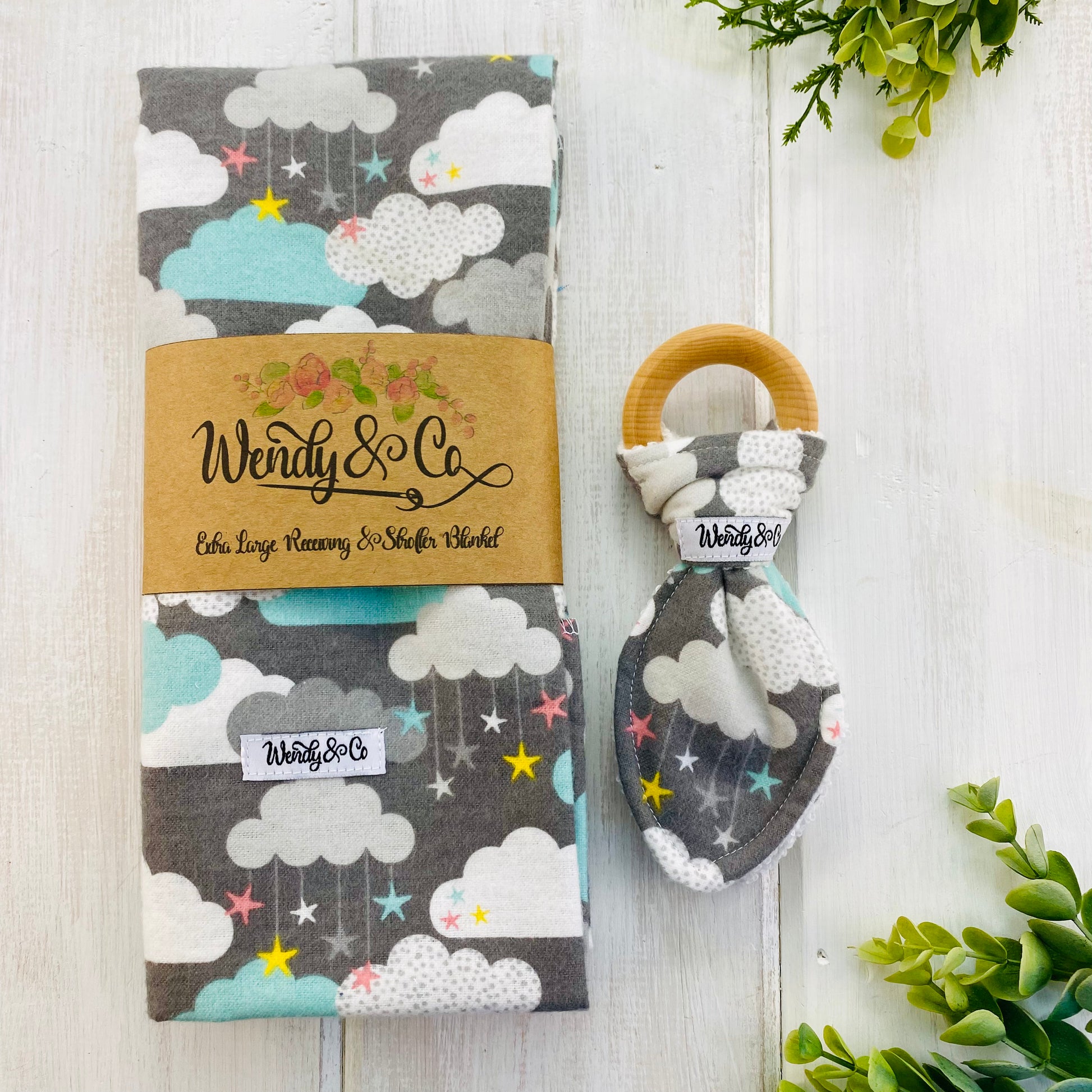 Baby gift set with flannel blanket and organic teether with clouds and stars.