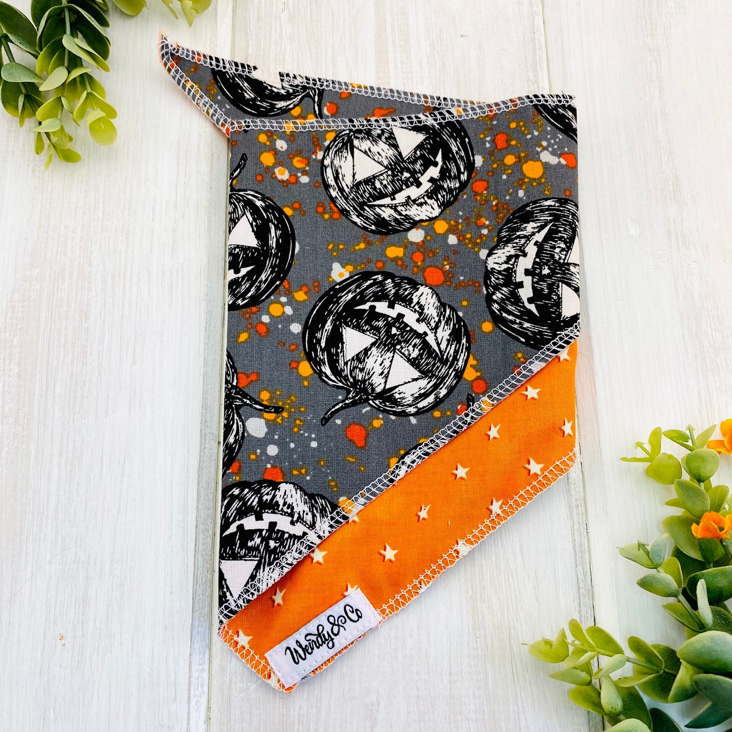 Tie on Halloween dog bandana with spooky pumpkins and glow in the dark stars.