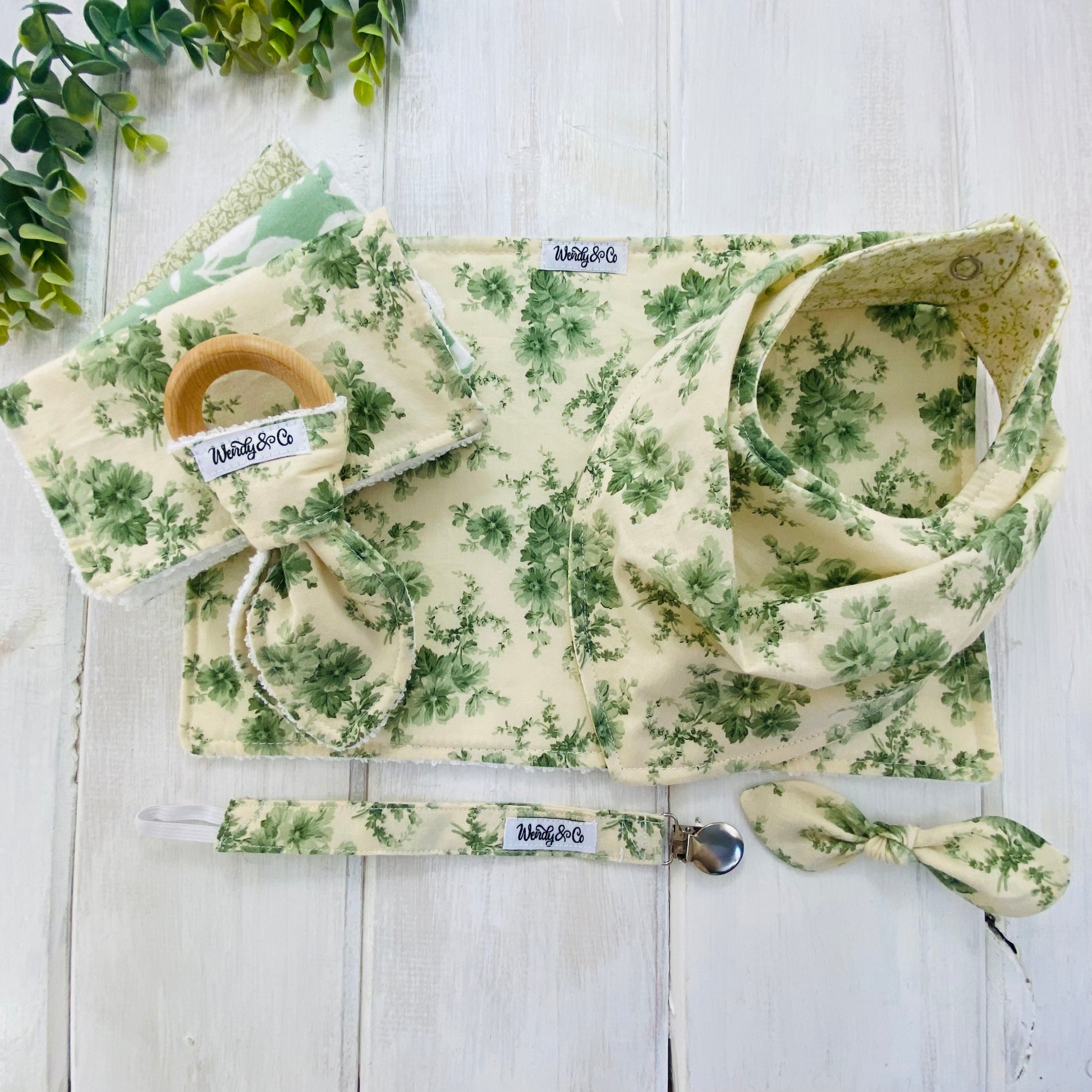 Beautiful heirloom sage floral baby gift set with bib, burp cloth, washing cloths, pacifier clip and teether.