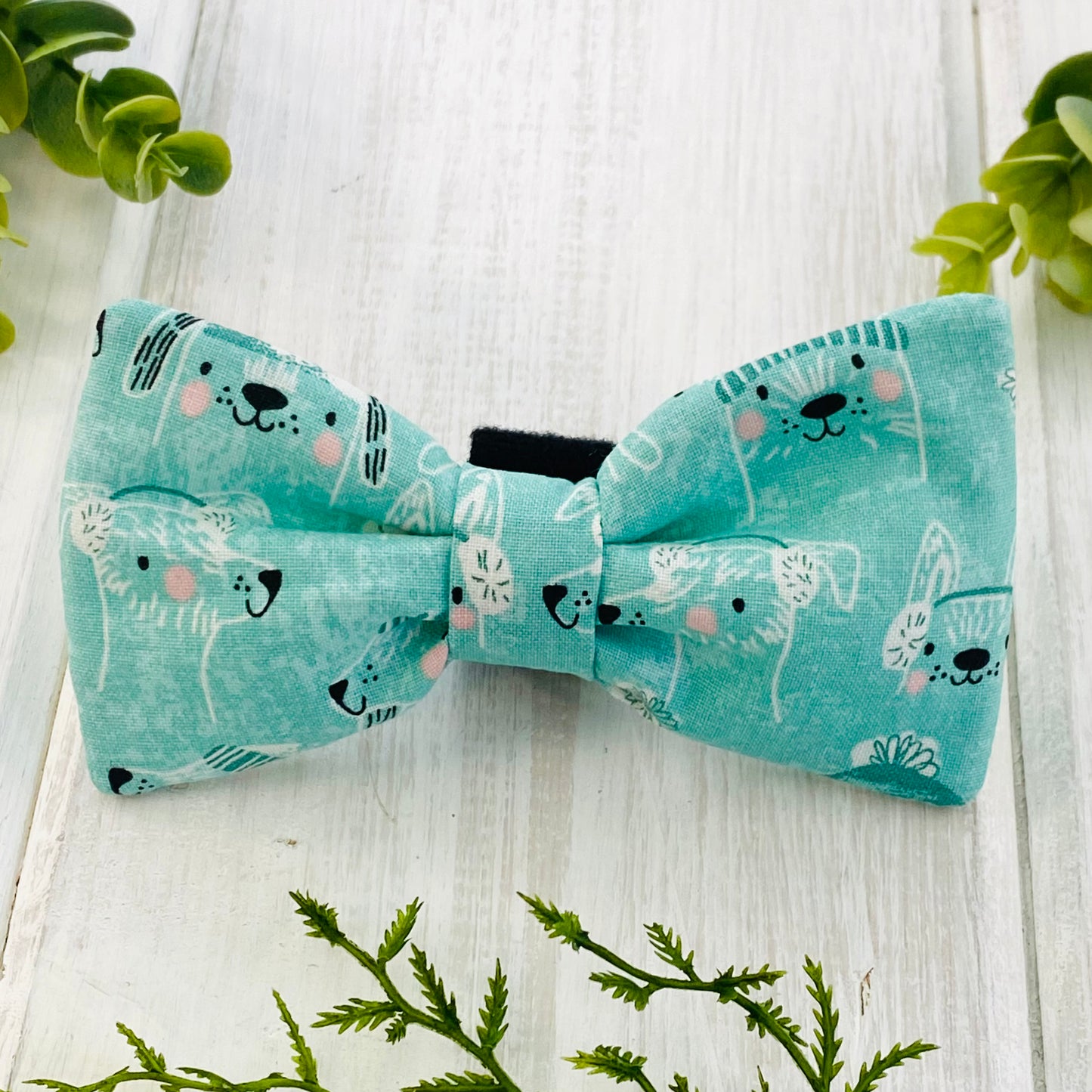 Mint green colored bow tie with dogs in white.