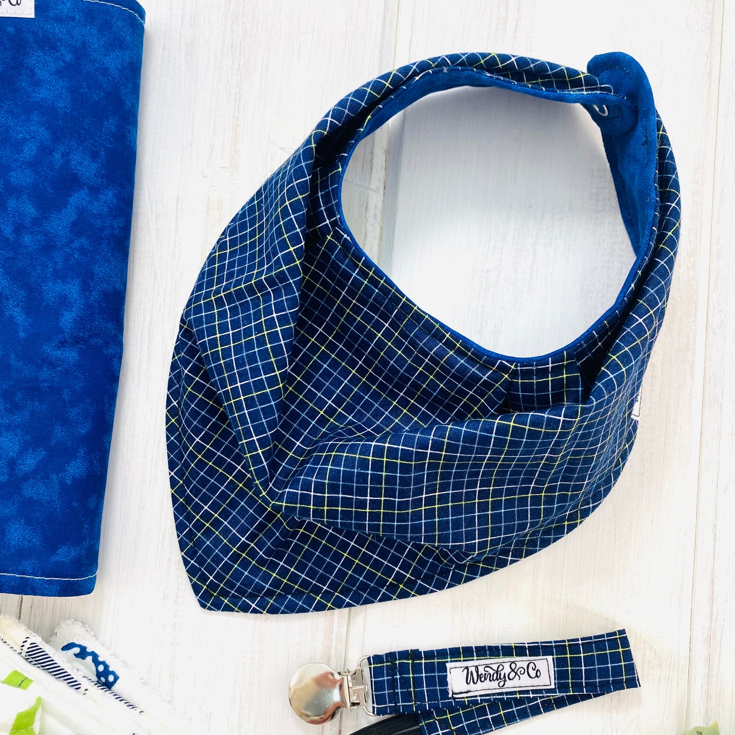 Reversible baby bib in navy plaid.