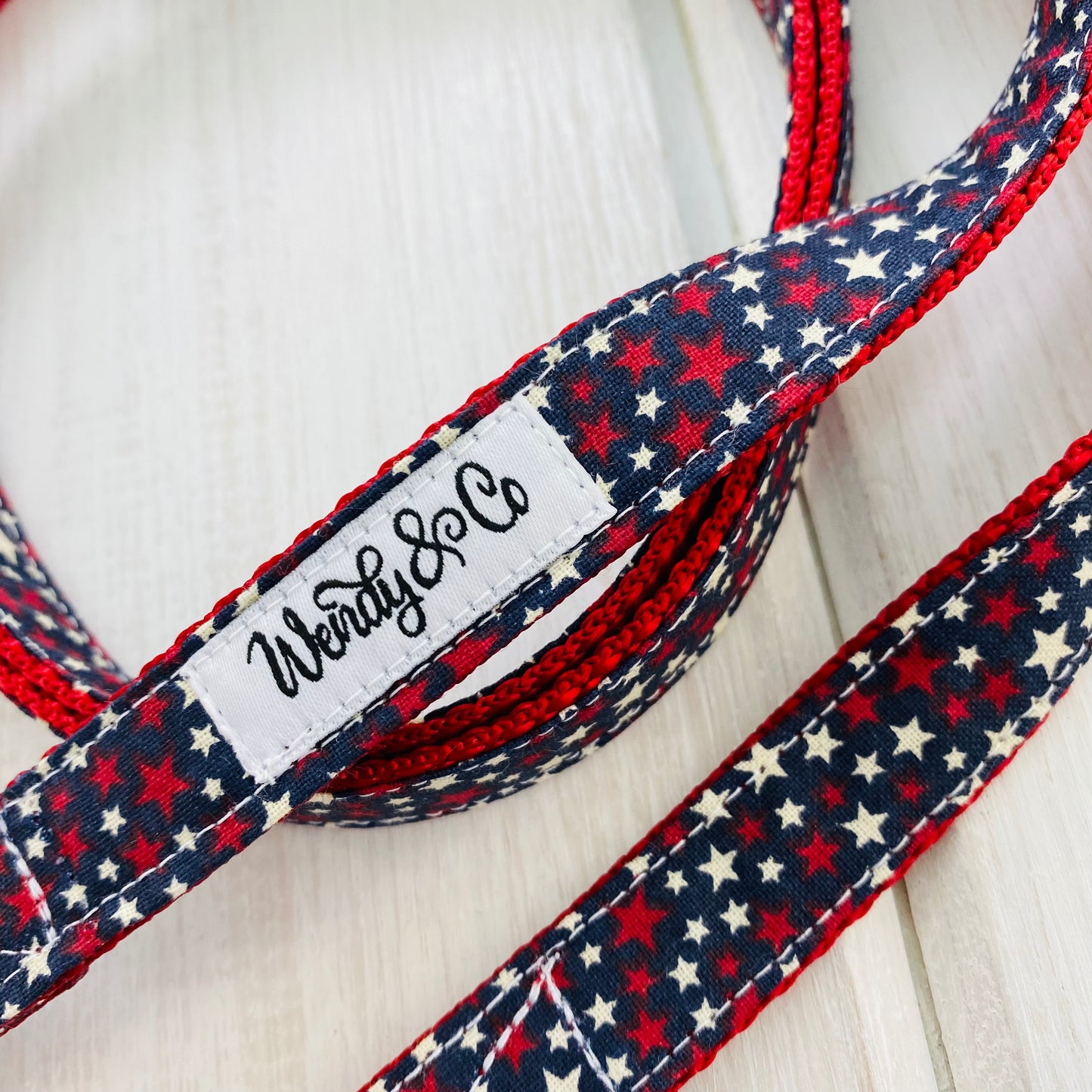 Dog leash- Navy fabric with red and white stars on red webbing.