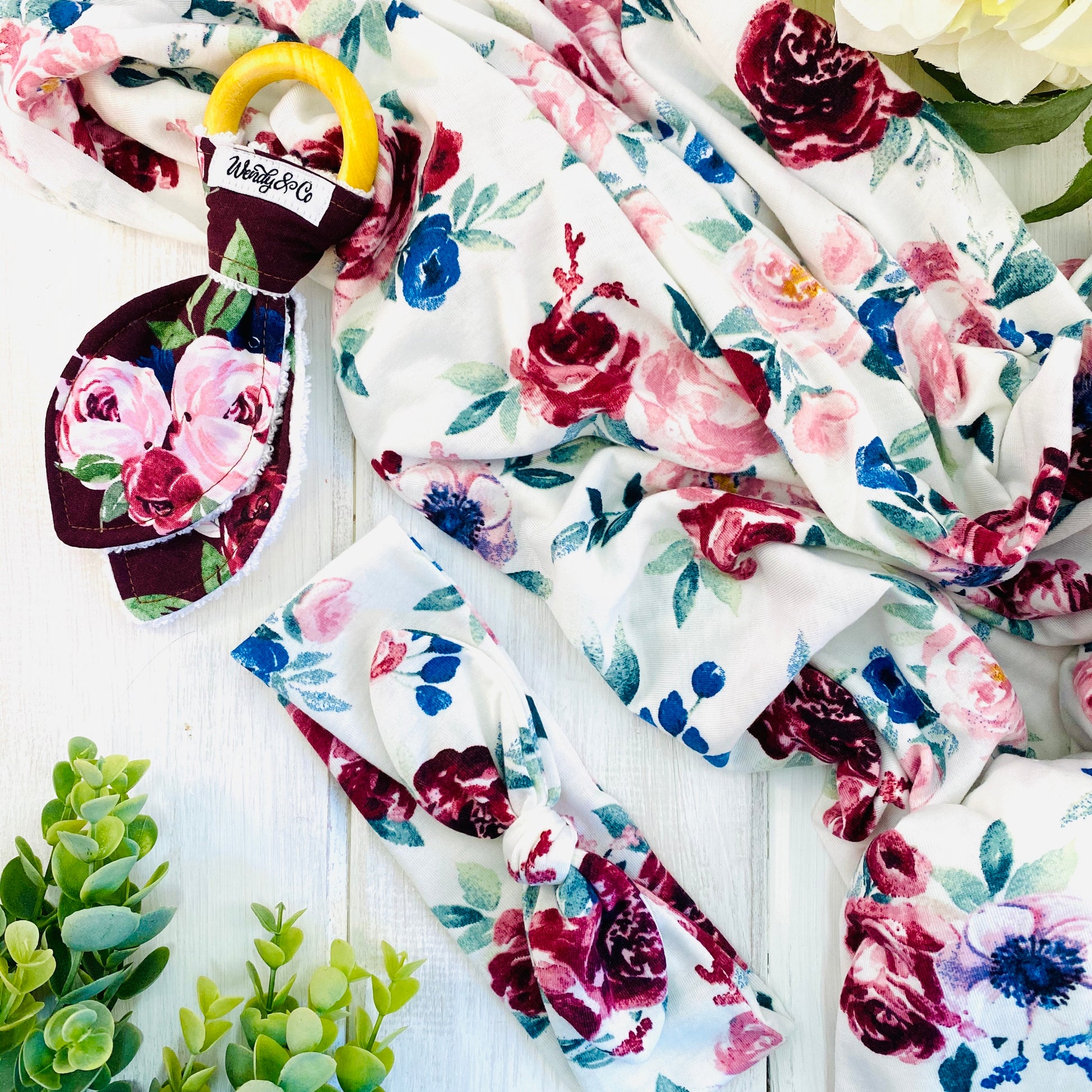 Soft stretchy swaddle set with headband, baby teether in maroon roses print.