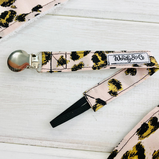 Blush pink cheetah animal print fabric with black and gold accents pacifier clip, paci holder, soother holder, metal clip.