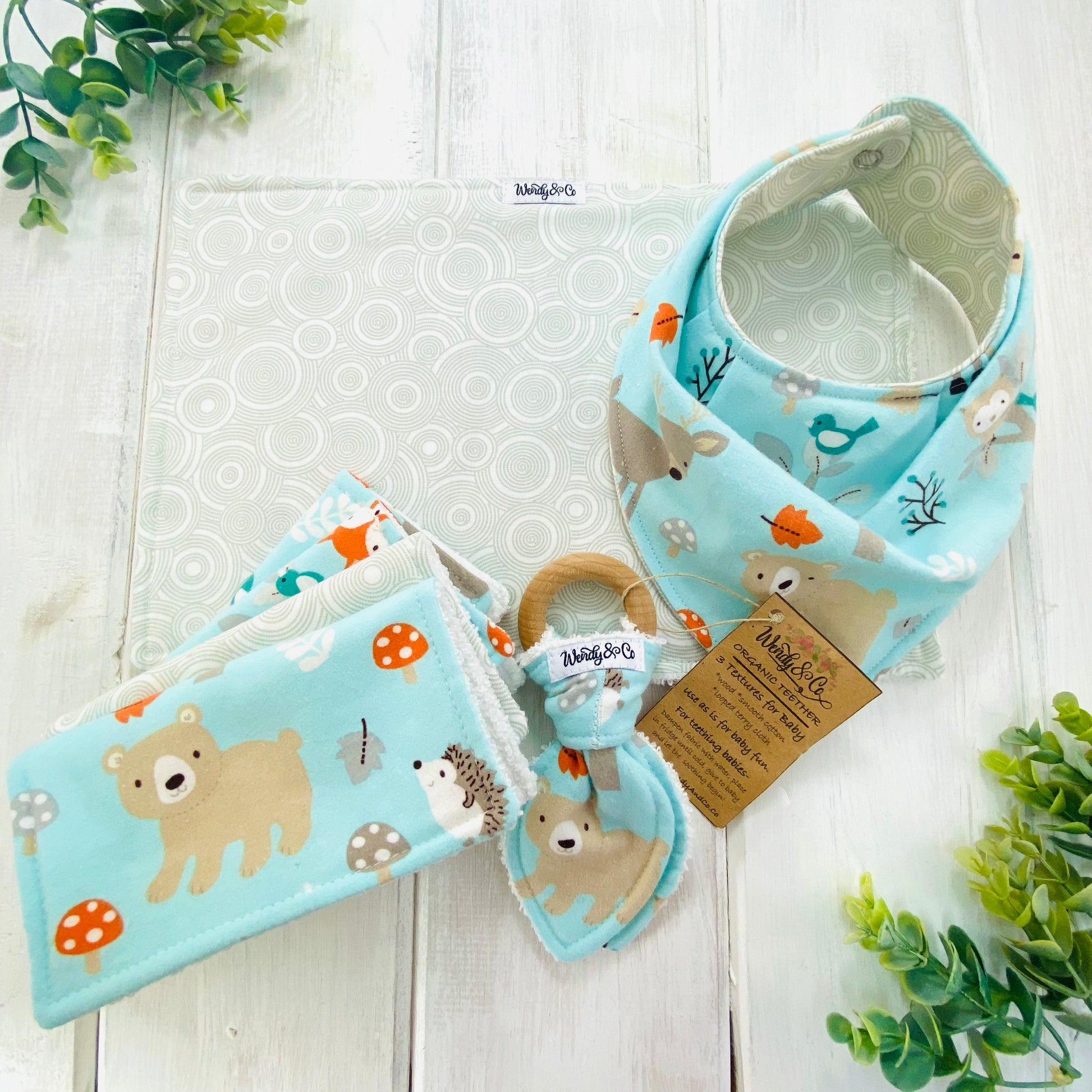 Soft baby blue woodland gift set for baby including bib, burp cloth, washing cloths, and teether.