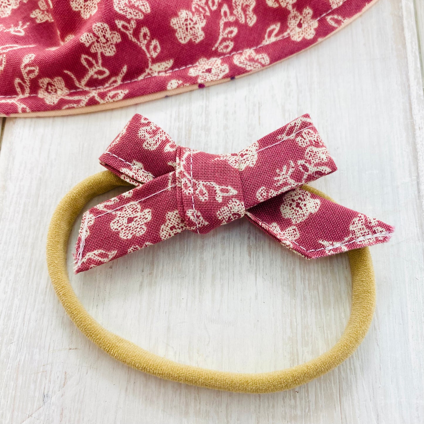 Primrose pink handtied bow on super soft baby headband.
