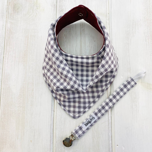 Gray check baby bib and pacifier clip.