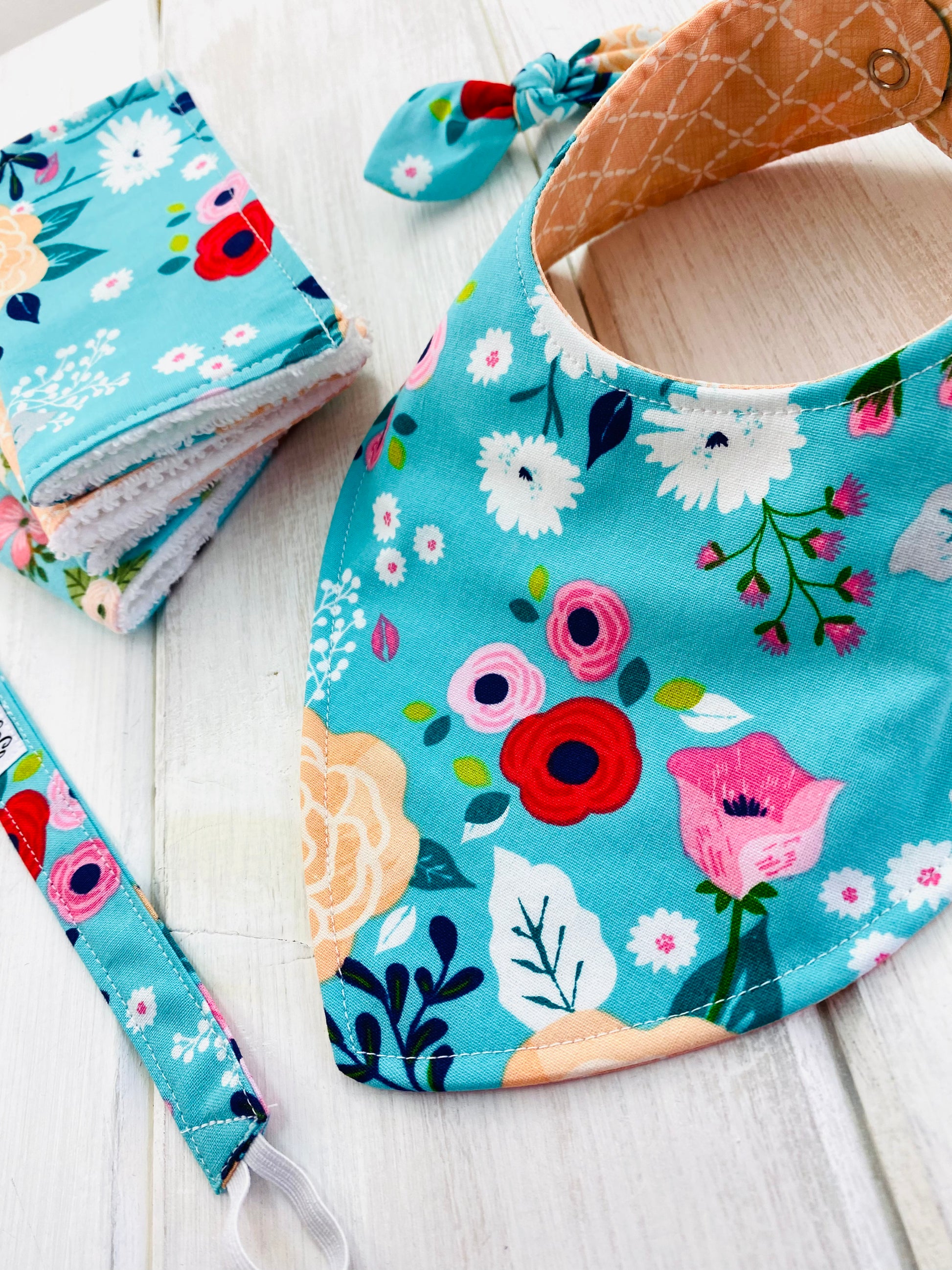 Designer baby accessories in bright floral print.