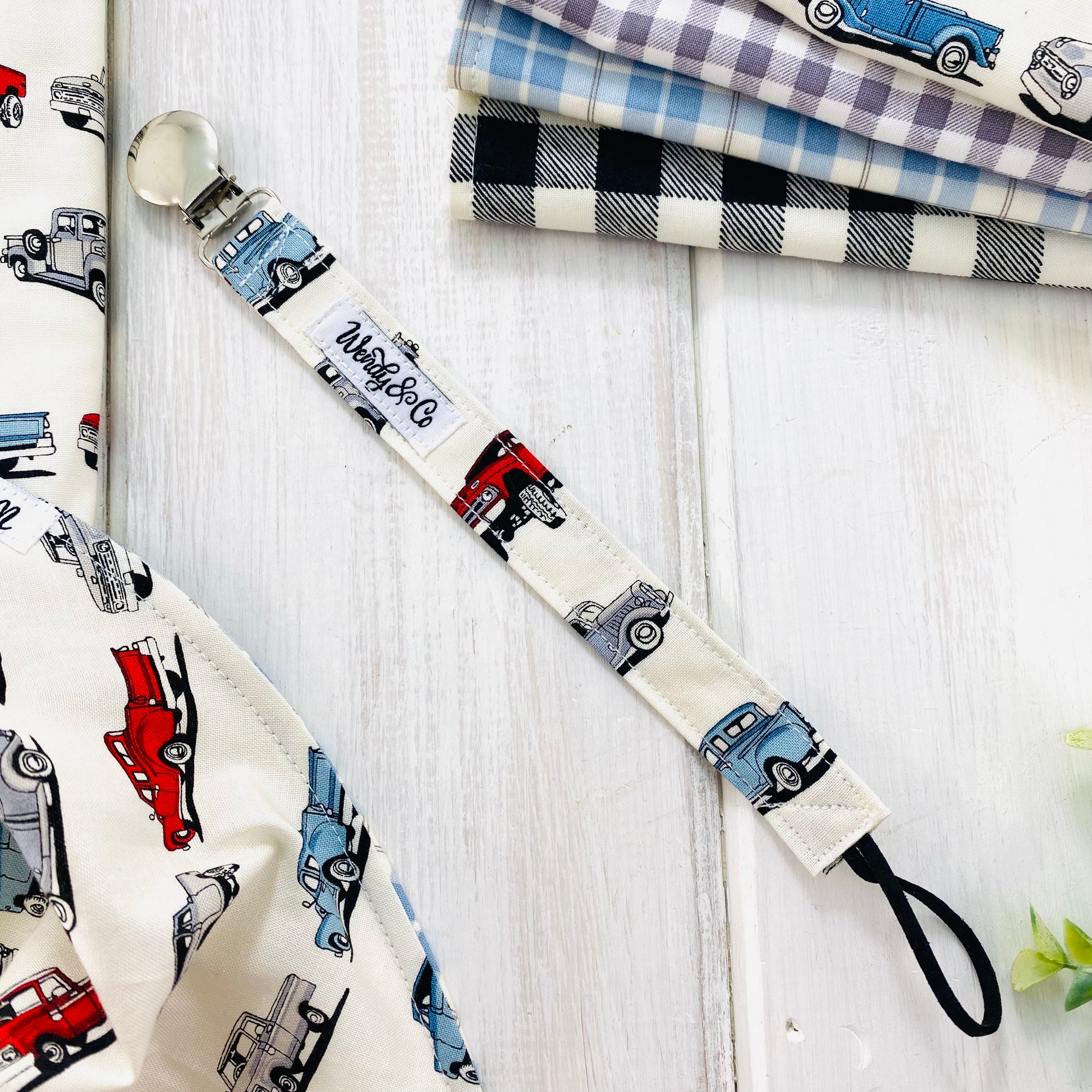 Pacifier clip or soother holder with old trucks.