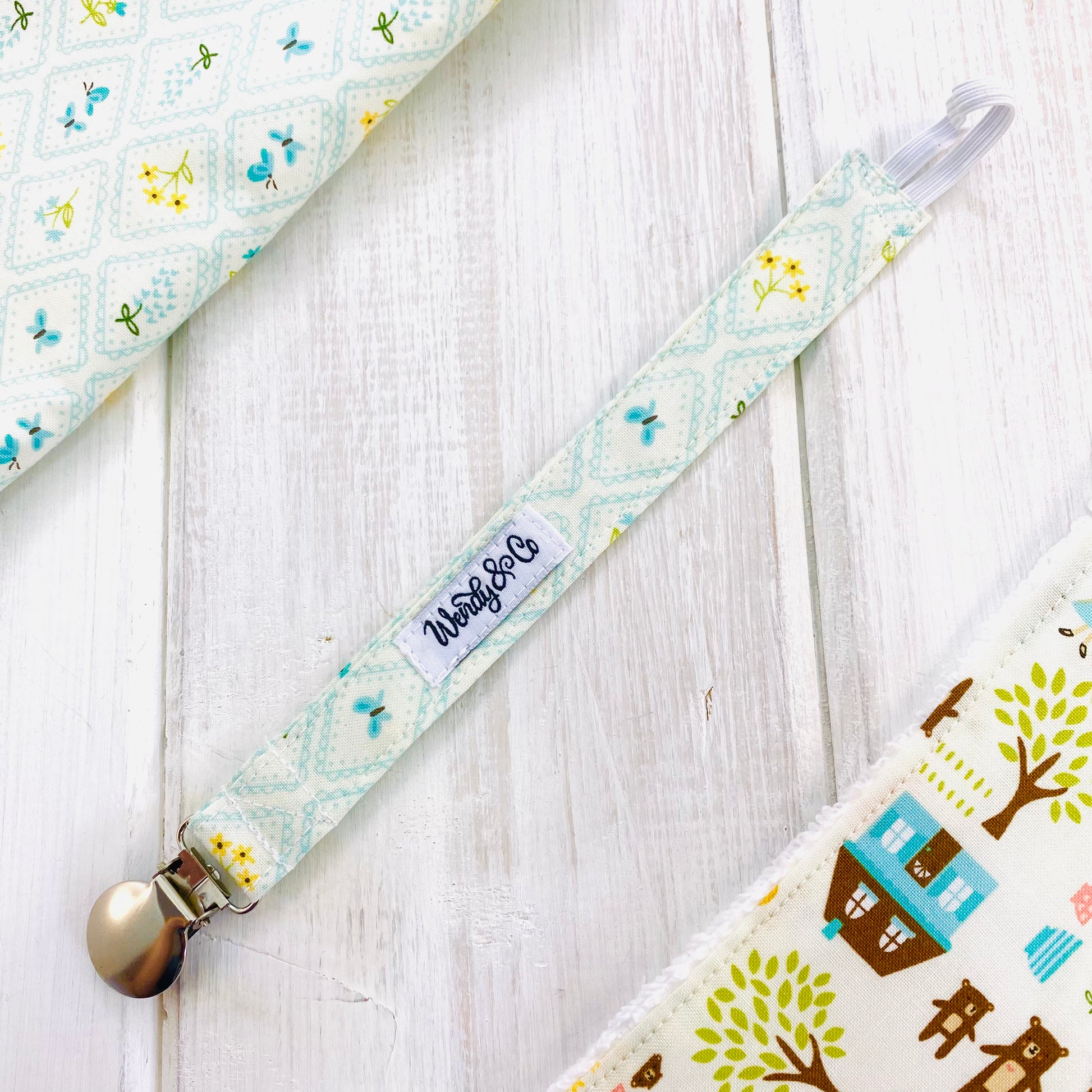 Blue grid with blue butterflies and yellow flower print paci clip