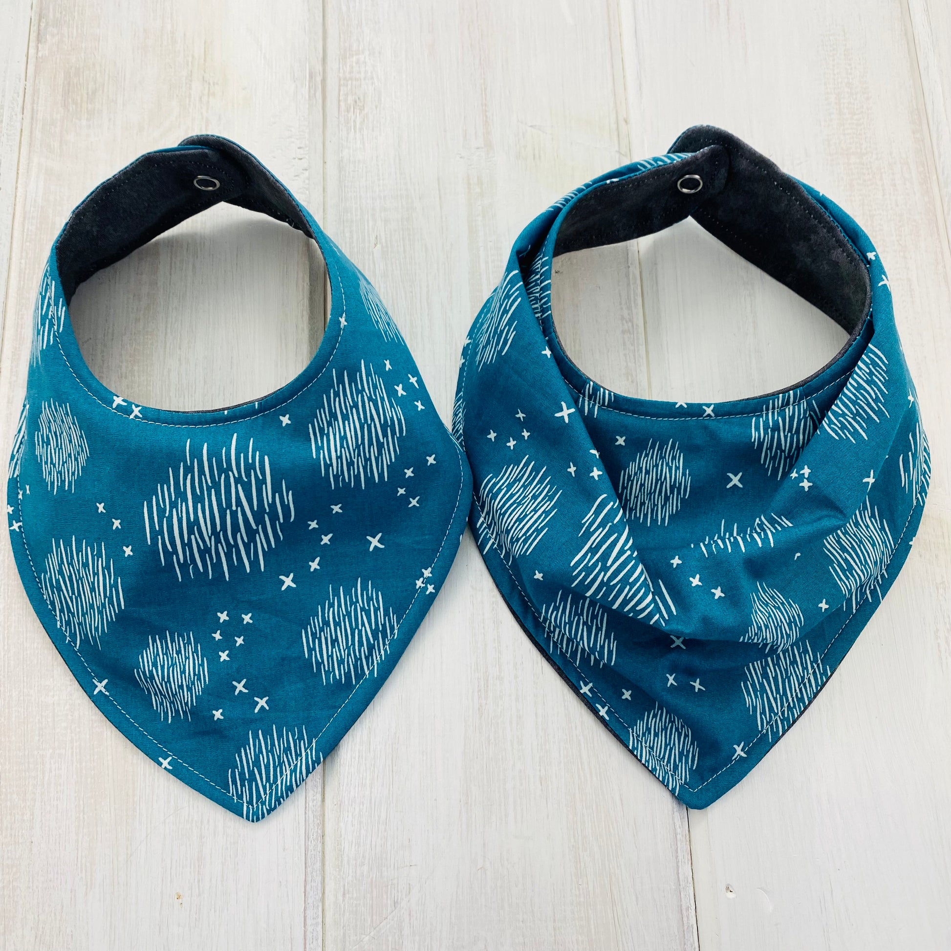 Bandana and smooth front baby bib show side by side.